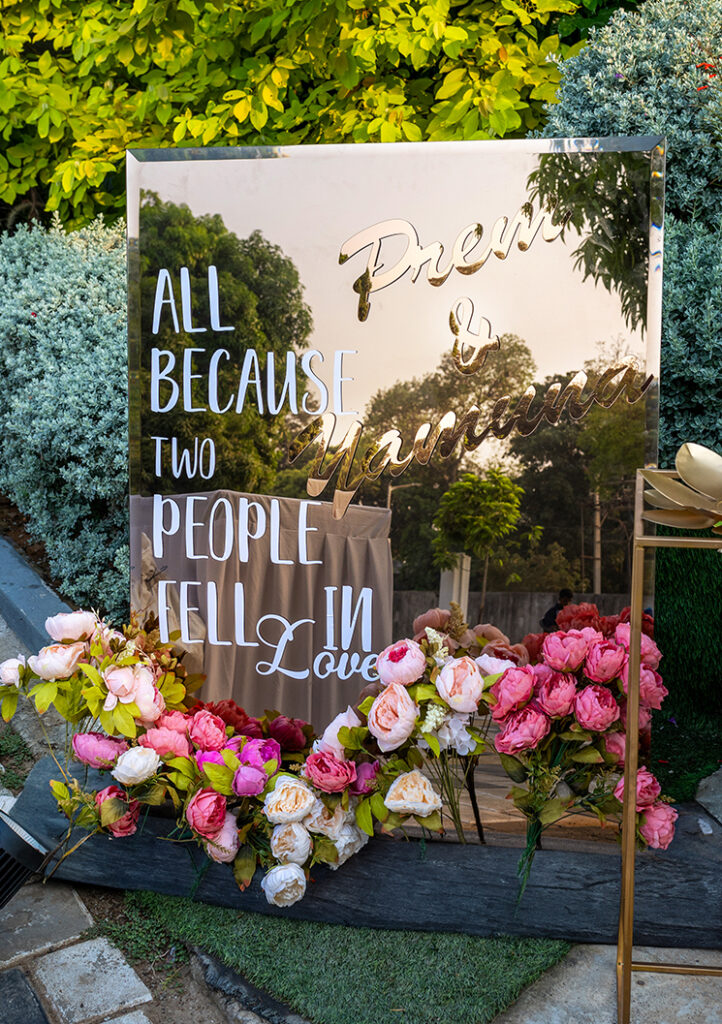 Elegant welcome board decoration with floral accents and stylish lettering by Artique Event Management